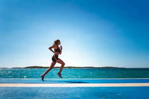 Woman running showing strong leg muscle Balsall